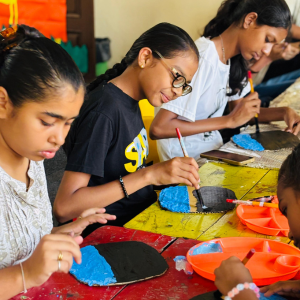 Camp counselor guiding children through a fun experiment