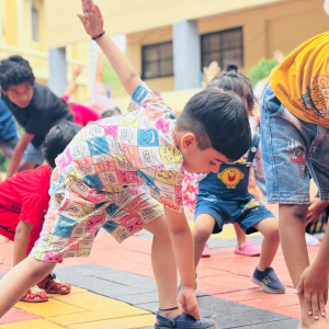 Children enjoying storytelling under a tree at SVPS Summer Camp